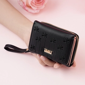 Women's short black PU leather wallet with daisy embroidery and secure zip closure