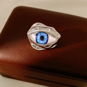 Irregular resin evil eye open ring with liquid metal waves and blue pupil detail
