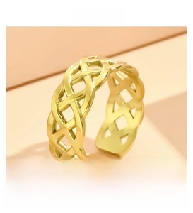 Macro shot of gold-plated stainless steel woven knot ring with hollow geometric patterns