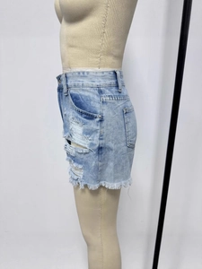 Women's slim fit light blue ripped denim shorts with fringe hem and side distressed detail