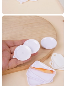 Miniature dollhouse white round and rectangular plates shown held by hand for scale
