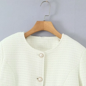 White tweed jacket for women featuring elegant pearl buttons and a classic round neck