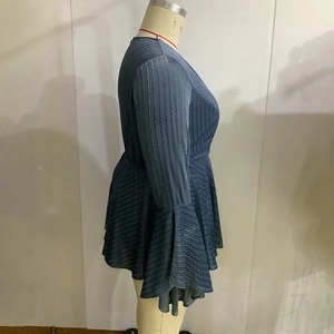 Detail of the blue flared long sleeves and wavy jacquard texture on this V-neck top