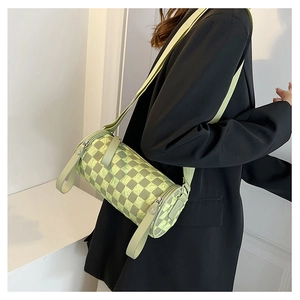 Detail of checkered barrel crossbody bag in light green and yellow with wide strap