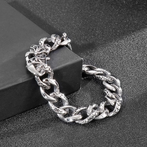Detailed view of heavy stainless steel chain bracelet with engraved dragon scale patterns