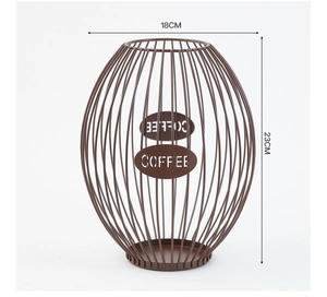 Detail of a brown wire coffee pod basket showing metal oval badge with COFFEE lettering