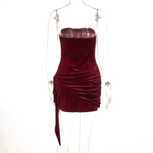 Detail of red velvet tube mini dress featuring elegant ruching and stylish side ribbons
