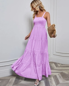 Detail of purple striped dress featuring a ruched bodice and layered tiered skirt style