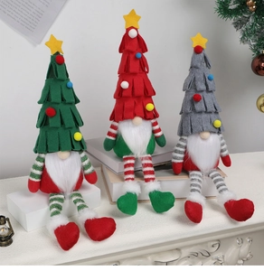 Close-up of three long-legged Christmas gnomes with tree-shaped hats and star details