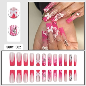 French pink gradient press-on nails with white bows, glitter, and floral accents