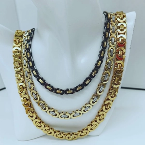 Three-tone Byzantine chain necklaces in gold, silver and black displayed on a neck model