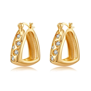 Macro view of gold plated U-shaped earrings with sparkling cubic zirconia star details