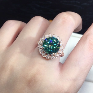 Luxurious rose gold ring featuring a green moissanite main stone and double halo diamonds