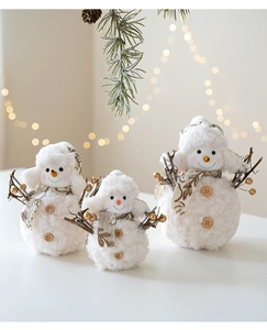 Three plush knitted Christmas snowmen in various sizes with warm holiday decorations