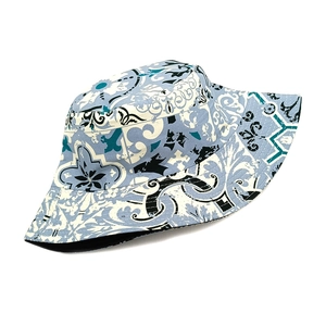 Detail of bohemian bucket hat with blue and white tile patterns and black inner lining