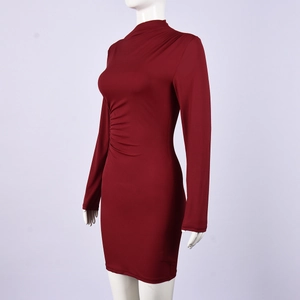Detail of burgundy ruched waist and side pleats on a long-sleeve evening dress