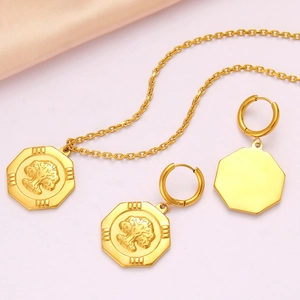 Detailed view of octagonal gold pendant necklace and matching earrings on pink fabric