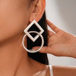 Detailed view of silver geometric earrings with hollow square and large hoop link