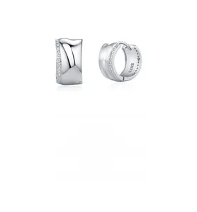Close-up of S925 sterling silver C-shaped earrings with polished finish and pavé zircons