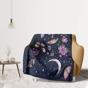Detail of soft flannel throw blanket featuring vintage blue moon and butterfly floral patterns