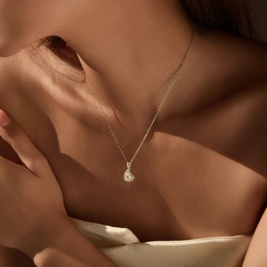 Elegant gold S925 silver necklace with teardrop moissanite pendant on professional model