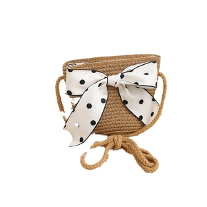 Straw mini crossbody bag with a large polka dot bow for summer beach vacations