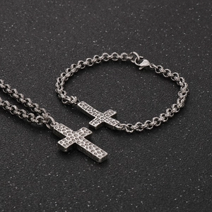 Close-up of hammered cross pendants on woven chains for vintage stainless steel jewelry set