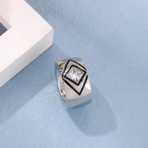 Macro view of wide stainless steel ring featuring an inset square-cut white zircon gem