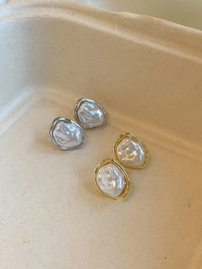 Detail view of gold and silver irregular pearl ear clips with vintage hammered texture