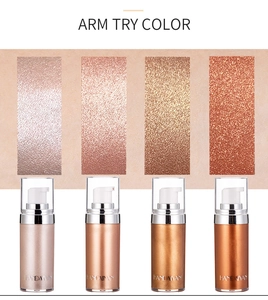 Arm swatches of four shades of liquid body highlighter showing metallic shimmer texture