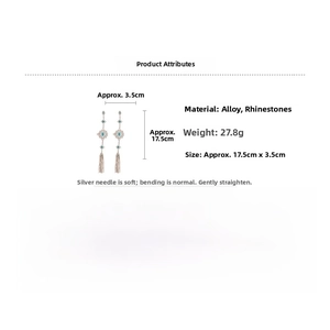 Detail of long fringe drop earrings with light blue rhinestones and gold-tone finish