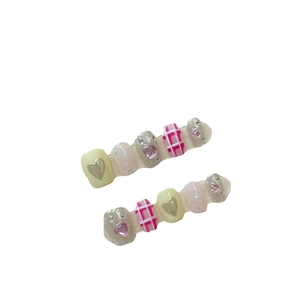 Short square press-on nails featuring Y2K chrome, yellow glitter, and heart charms