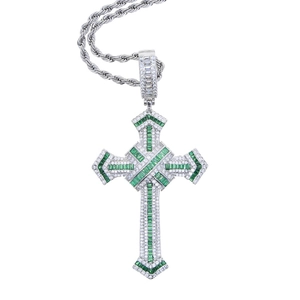 Close-up of hip hop cross pendant with green and white cubic zirconia stones on silver chain