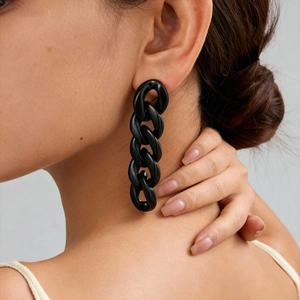 Edgy black acrylic chain drop earrings for women showing a unique link style on a model