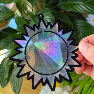 Macro detail of sun-shaped holographic suncatcher prism creating rainbow light effects