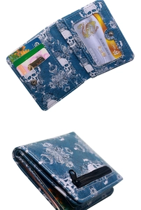 Detail of blue skull print wallet showing internal card slots and a black zipper pocket