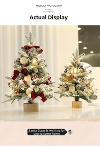 Detail of mini flocked Christmas trees with red bows, LED lights and wooden base