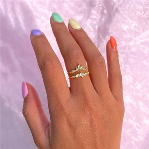 Detail view of stackable S925 silver rings with marquise-cut green and white zircons