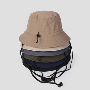 Stack of outdoor nylon quick-dry sun hats with adjustable wind ropes in various colors
