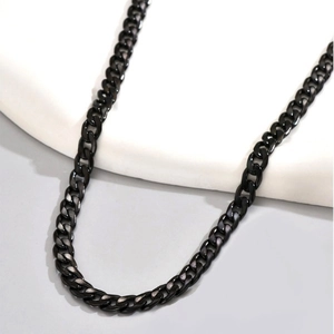 Classic black stainless steel Cuban link chain necklace displayed on a white stand