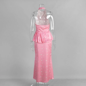 Detail of pink floral satin maxi skirt with a halter neck and peplum waist detail