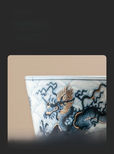 Detailed view of the smooth rim and gold-inlaid dragon pattern on ceramic tea cup