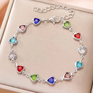 Elegant silver metal bracelet featuring twelve multi-color heart-shaped gemstones