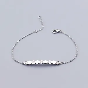 Detail of minimalist silver hexagonal bracelet with sparkling cubic zirconia settings
