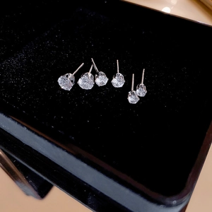 Macro shot of six S925 silver stud earrings with round cubic zirconia in a jewelry box