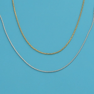 18k gold and silver plated stainless steel snake chain necklaces on blue background