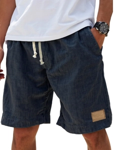 Detail of navy linen casual shorts featuring adjustable drawstring waist and fabric texture