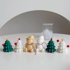 Minimalist hand-painted Christmas tree and bear candles in premium holiday packaging