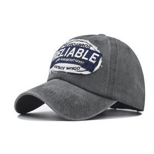 Close-up of vintage grey washed cotton baseball cap with Reliable embroidery detail