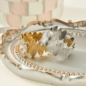 Vintage 18k gold and silver marquise zircon rings with wavy bands on retro tray